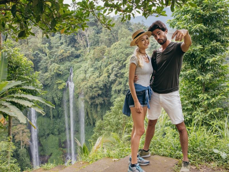 beautiful-couple-together-on-cliff-taking-selfie