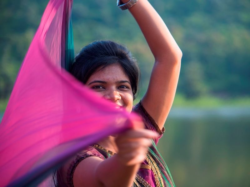 young-happy-indian-girl-playing-with-her-pink-scar
