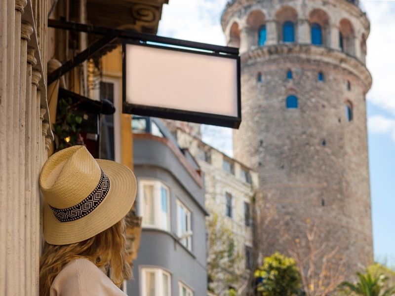 a-girl-in-a-hat-looks-at-the-galata-tower