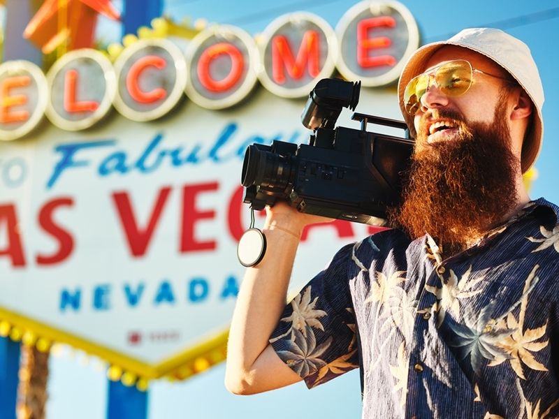 retro-tourist-with-80s-vintage-camcorder-standing